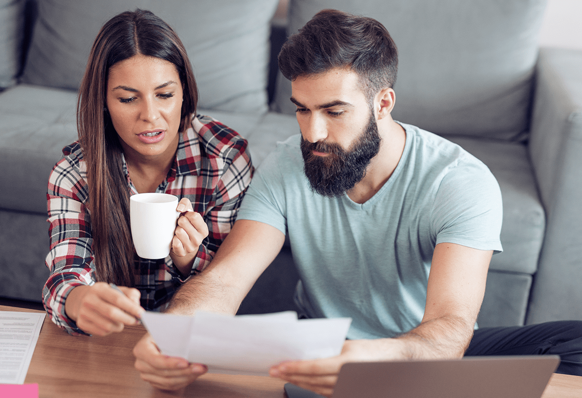 An image of couple going through their bill.